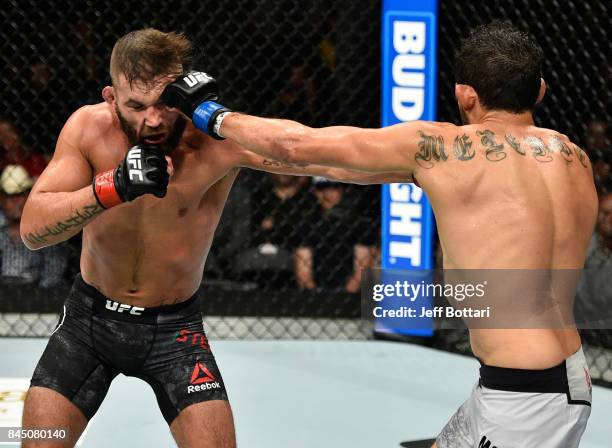 Gilbert Melendez punches Jeremy Stephens in their featherweight bout during the UFC 215 event inside the Rogers Place on September 9, 2017 in...