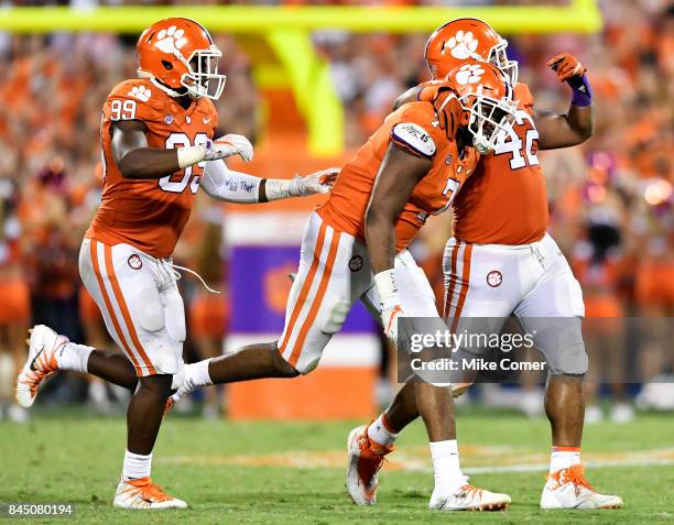 Defensive end Austin Bryant, defensive end Clelin Ferrell, and defensive lineman Christian Wilkins of the Clemson Tigers celebrate following a sack...