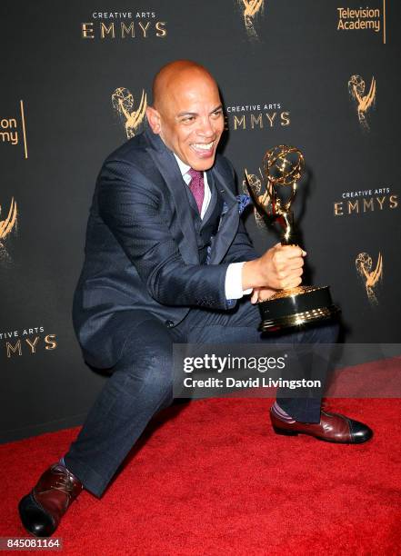 Music producer Rickey Minor poses in the press room with the award for outstanding music direction for "Stayin' Alive: A Grammy Salute to the Music...