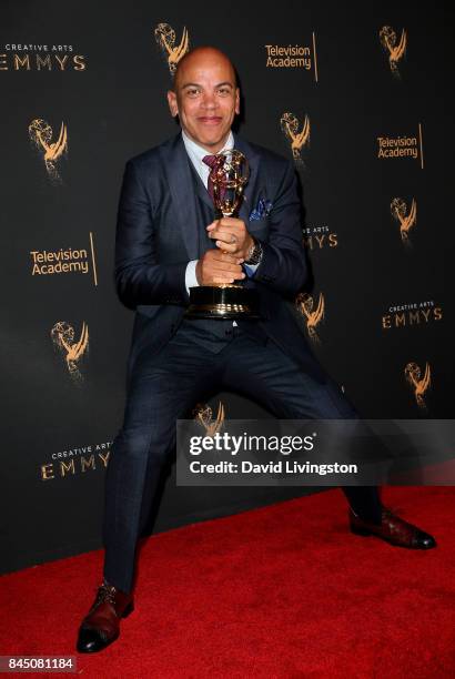 Music producer Rickey Minor poses in the press room with the award for outstanding music direction for "Stayin' Alive: A Grammy Salute to the Music...