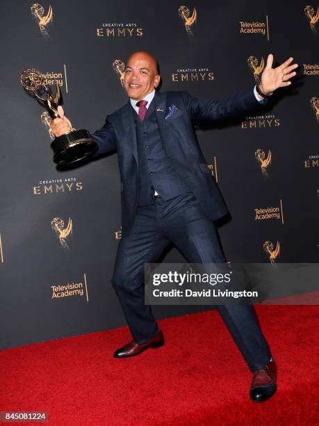 Music producer Rickey Minor poses in the press room with the award for outstanding music direction for "Stayin' Alive: A Grammy Salute to the Music...