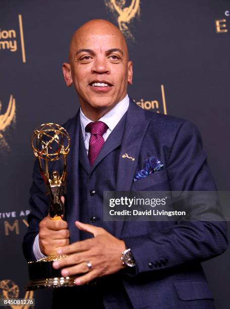 Music producer Rickey Minor poses in the press room with the award for outstanding music direction for "Stayin' Alive: A Grammy Salute to the Music...