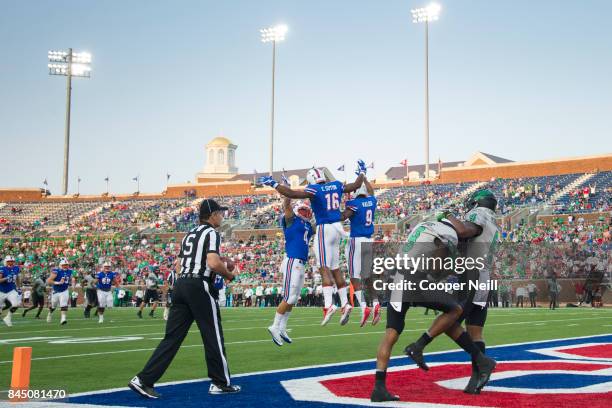 Courtland Sutton of the SMU Mustangs celebrates with teammates after scoring a touchdown against the North Texas Mean Green during the first half at...