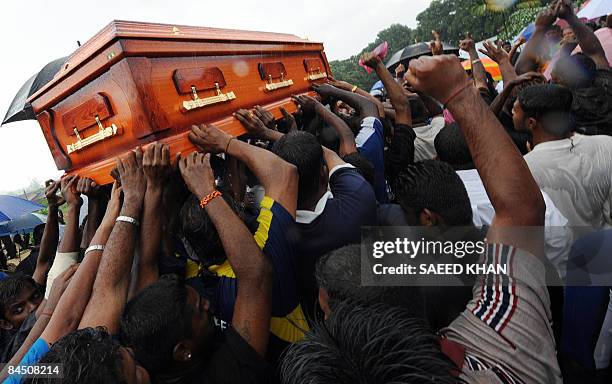 Ethnic Indians carry the coffin of Ananthan Kugan for burial in Puchong outside Kuala Lumpur city on Januray 28, 2009. Malaysian police arrested five...