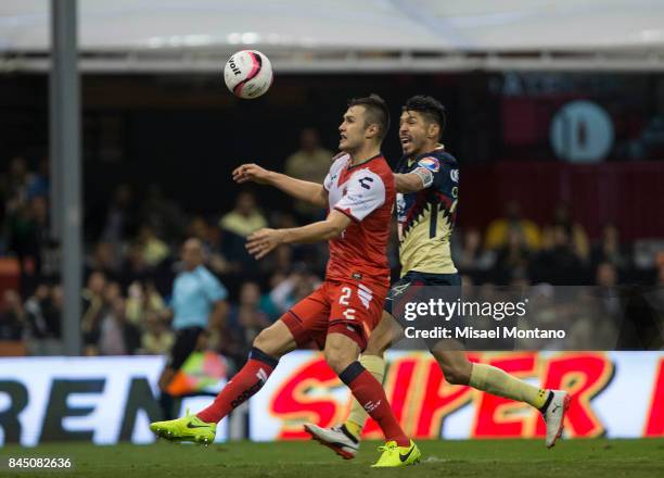 Oribe Peralta of America competes for the ball with Kristian Alvarez of Veracruz during the 8th round match between America and Veracruz as part of...