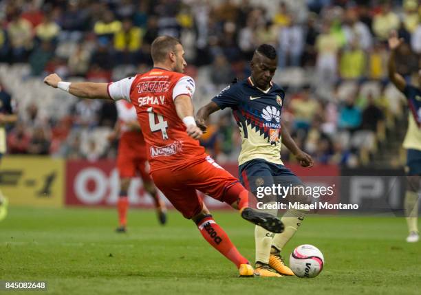 Darwin Quintero of America fights for the ball with Jose Velazquez of Veracruz during the 8th round match between America and Veracruz as part of the...