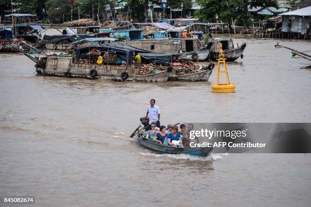 In this July 17, 2017 photograph, tourists ride a boat in a canal off the Song Hau river in the floating Cai Rang market in Can Tho, a small city of...