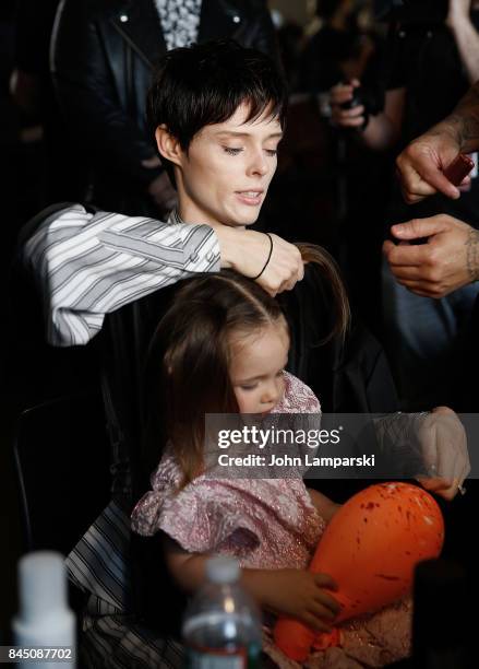 Coco Rocha and her doughter, Ioni James Conran prepare backstage during the Christian Siriano collection during the September 2017 New York Fashion...