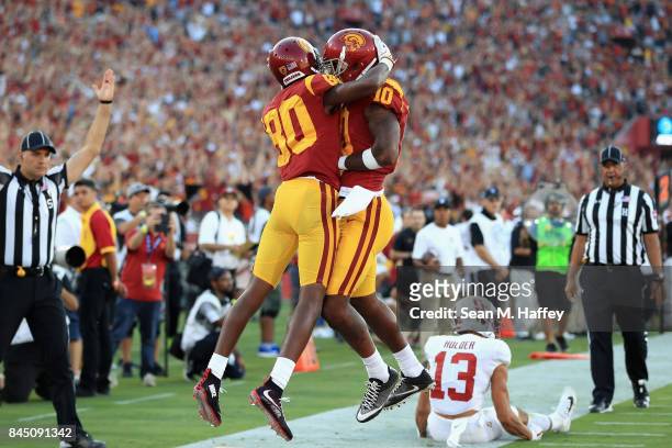 Deontay Burnett of the USC Trojans celebrates with Jalen Greene after scoring a second quarter touchdown against the Stanford Cardinal at Los Angeles...