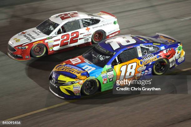 Kyle Busch, driver of the M&M's Caramel Toyota, races Joey Logano, driver of the Shell Pennzoil/Red Cross Ford, during the Monster Energy NASCAR Cup...