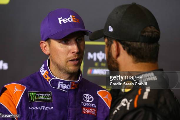 Denny Hamlin, driver of the FedEx Express Toyota, speaks with Martin Truex Jr., driver of the Auto-Owners Insurance Toyota, following the Monster...