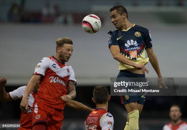 Paul Aguilar of America heads for the ball with Cristian Menendez of Veracruz during the 8th round match between America and Veracruz as part of the...