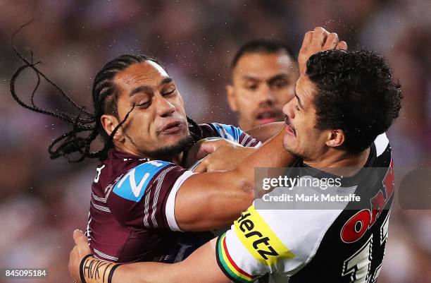 Martin Taupau of the Sea Eagles is tackled by Corey Harawira Naera of the Panthers during the NRL Elimination Final match between the Manly Sea...