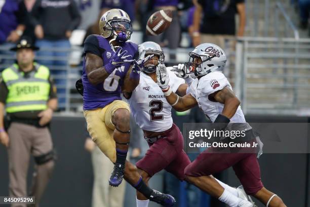 Wide receiver Chico McClatcher of the Washington Huskies has this pass batted away in the end zone by cornerback Ryan McKinley and safety Justin...