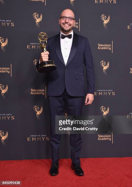 Anthony Miale poses in the press room with the award for outstanding picture editing for variety programming for "Last Week Tonight with John Oliver"...