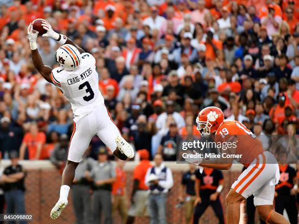 Safety Tanner Muse of the Clemson Tigers lies in wait as wide receiver Nate Craig-Myers of the Auburn Tigers brings in the football for a reception...