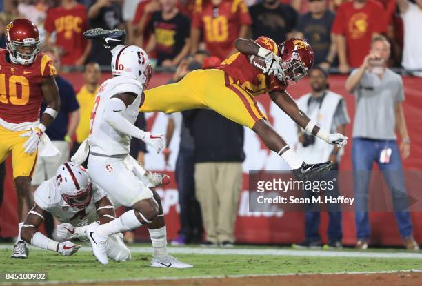 Ronald Jones II of the USC Trojans jumps into the end zone to score a fourth quarter touchdown against the Stanford Cardinal at Los Angeles Memorial...