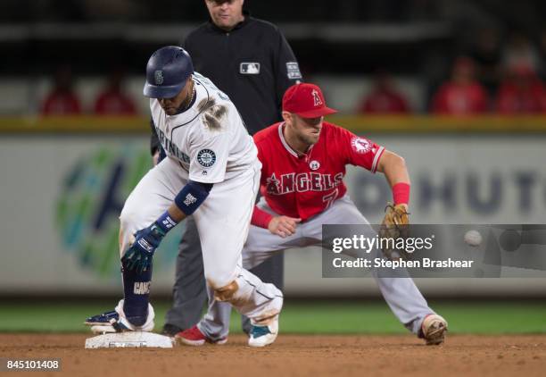 Robinson Cano of the Seattle Mariners slides safely into second base before shortstop Cliff Pennington of the Los Angeles Angels of Anaheim can catch...