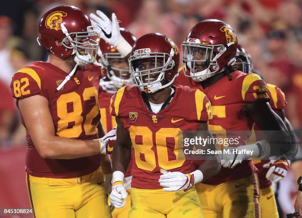Ronald Jones II of the USC Trojans celebrates with Tyler Petite and Deontay Burnett after scoring a touchdown during the fourth quarter against the...