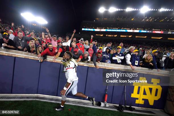 Georgia Bulldogs linebacker Davin Bellamy celebrates with fans after the NCAA football game between the Notre Dame Fighting Irish and the Georgia...