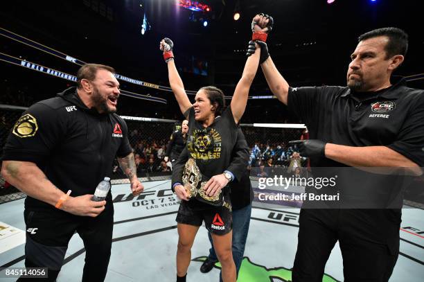 Amanda Nunes of Brazil celebrates her victory over Valentina Shevchenko of Kyrgyzstan in their women's bantamweight bout during the UFC 215 event...