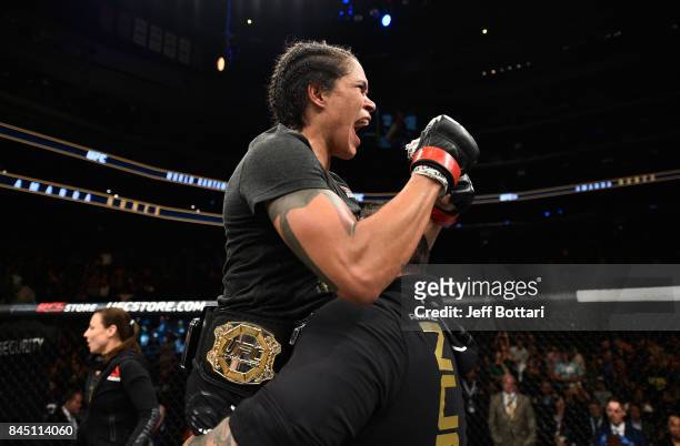 Amanda Nunes of Brazil celebrates her victory over Valentina Shevchenko of Kyrgyzstan in their women's bantamweight bout during the UFC 215 event...