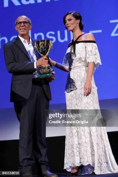 Kamel El Basha receives the Coppa Volpi for Best Actor Award for The Insult from jury member Anna Mouglalis during the Award Ceremony of the 74th...