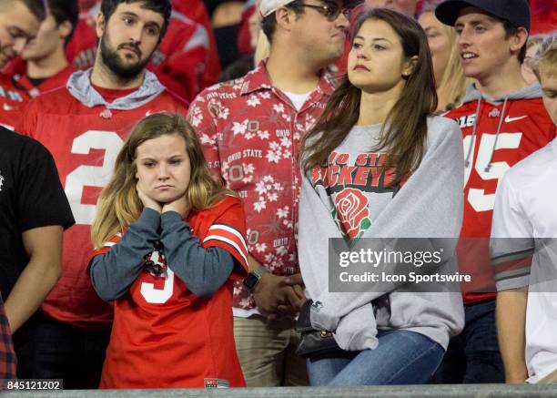 Two female Ohio State Buckeyes fans looking dejected in the fourth quarter of the game between the Ohio State Buckeyes and the Oklahoma Sooners on...