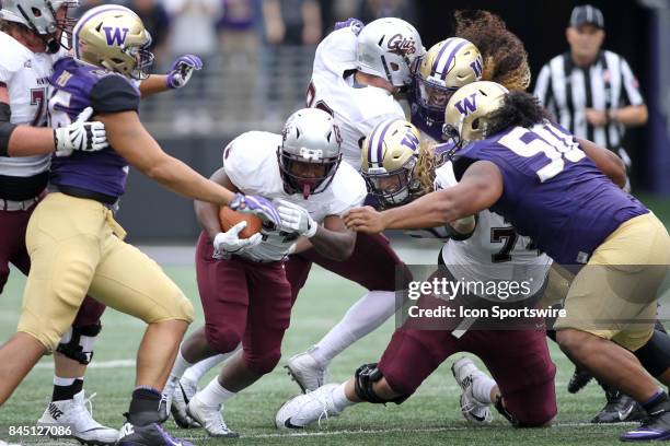 Washington's Jared Pulu , Ben Burr-Kirven and Vita Vea mov in to tackle Montana Alijah Lee at the end of a run during a college football game between...