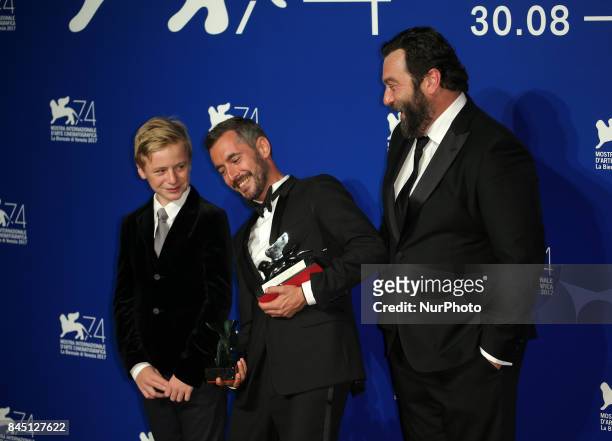 Thomas Gioria, Xavier Legrand and Denis Menochet pose with the Silver Lion for Best Director Award for 'Jusqu' la Garde' and the 'Luigi De...