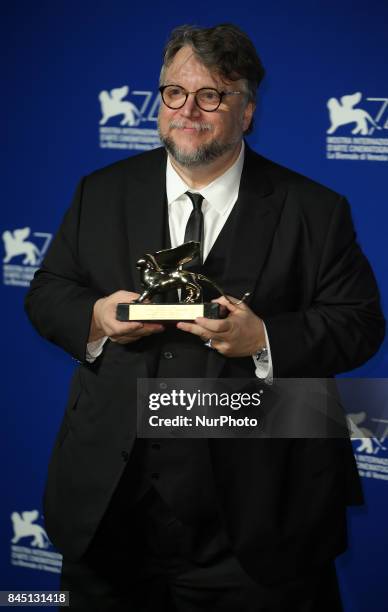 Guillermo del Toro poses with the Golden Lion for Best Film Award for 'The Shape Of Water' at the Award Winners photocall during the 74th Venice Film...