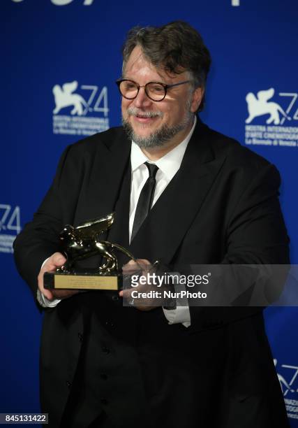 Guillermo del Toro poses with the Golden Lion for Best Film Award for 'The Shape Of Water' at the Award Winners photocall during the 74th Venice Film...