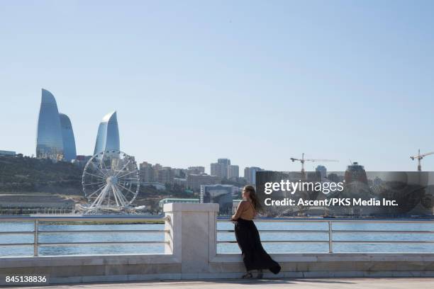 young woman looks across city landscape - baku 2017 stock-fotos und bilder