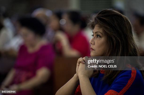 Imee Marcos, daughter of former Philippine president and late dictator Ferdinand Marcos, attends a mass at the Immaculate Conception Parish during...