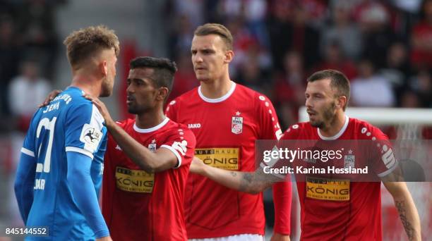 Ahmed Waseem Razeek, Florian Neuhold and Carsten Kammlott of Erfurt talk to Dennis Slamar of Jena during the 3.Liga match between FC Rot Weiss Erfurt...