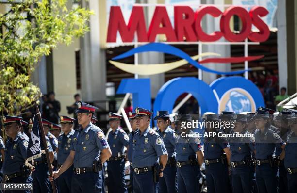 Policemen stand in formation during celebrations to mark his 100th birthday of late dictator Ferdinand Marcos in Batac, Ilocos Norte province, north...