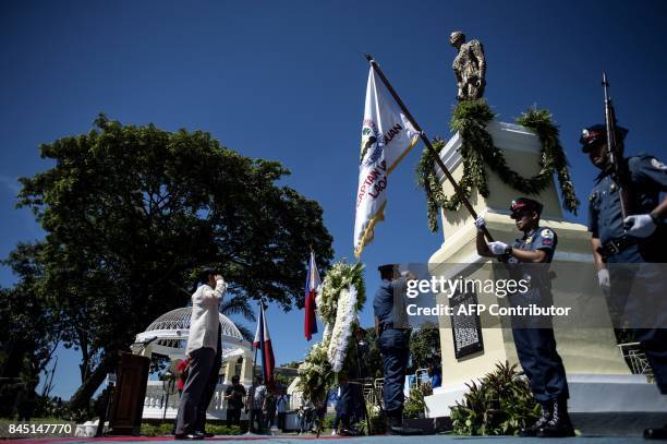 Ferdinand "Bongbong" Marcos Jnr , a former senator and son of the late dictator Ferdinand Marcos, salutes in front of a monument dedicated to his...