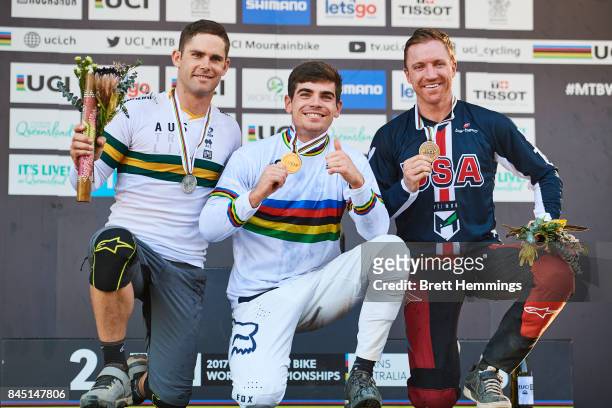 Loic Bruni of France , Michael Hannah of Australia and Aaron Gwin of the USA celebrate on the podium for the Elite Mens Downhill race during the 2017...