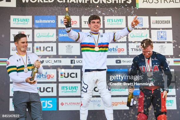 Loic Bruni of France , Michael Hannah of Australia and Aaron Gwin of the USA celebrate on the podium for the Elite Mens Downhill race during the 2017...