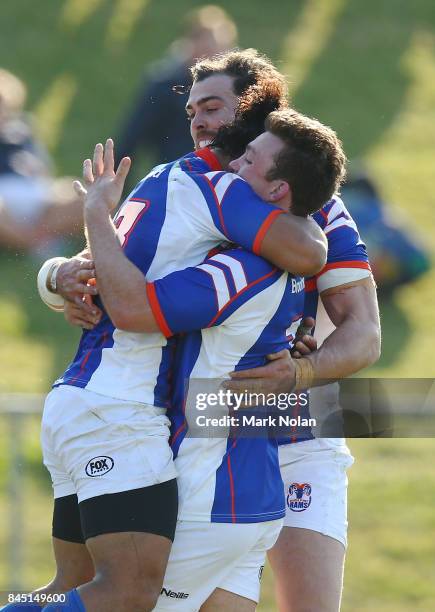 Dennis Pili-Gaitau of the Rams celebrates scoring a try with team mates during the round two NRC match between the Rays and the Rams at Macquarie Uni...