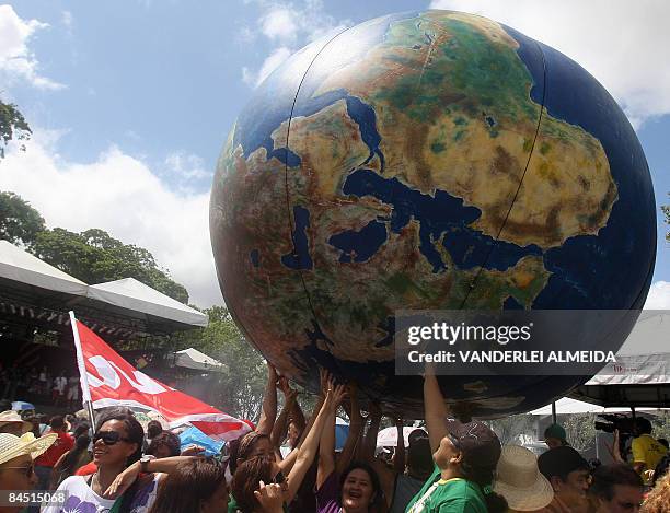 People transport a globe in a parade held during the World Social Forum in Belem, in Para, in the heart of the Brazilian Amazon, on January 28, 2009....