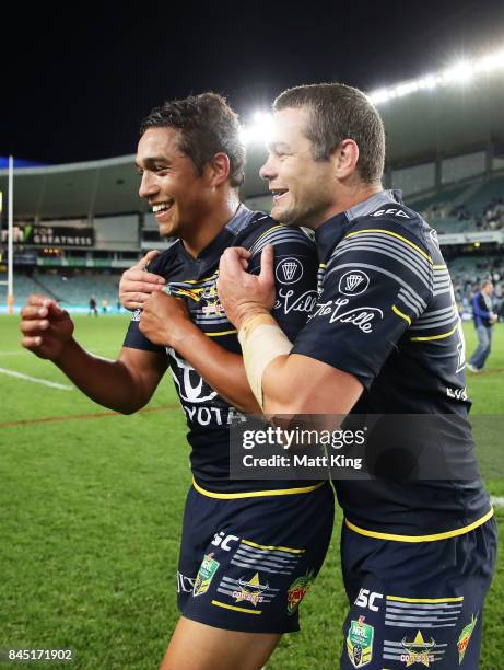 Te Maire Martin of the Cowboys and Shaun Fensom of the Cowboys celebrate victory at the end of during the NRL Elimination Final match between the...