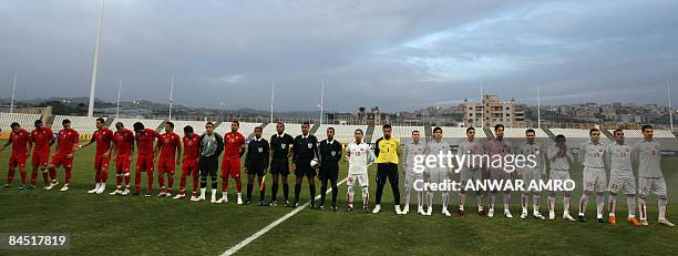 The Syrian and the Lebanese national football teams line up with the match officials before kick-off of their group D 2011 Asian Cup qualifying...