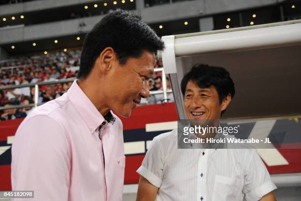 Head coach Go Oiwa of Kashima Antlers and Head coach Akira Ito of Omiya Ardija greet prior to the J.League J1 match between Kashima Antlers and Omiya...