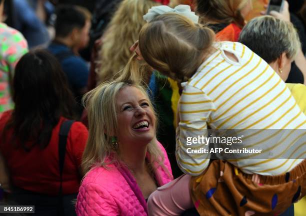 Australia's opposition leader Bill Shorten's daugther Clementine plays with her mother Chloe's hair at a same-sex marriage rally in Sydney on...