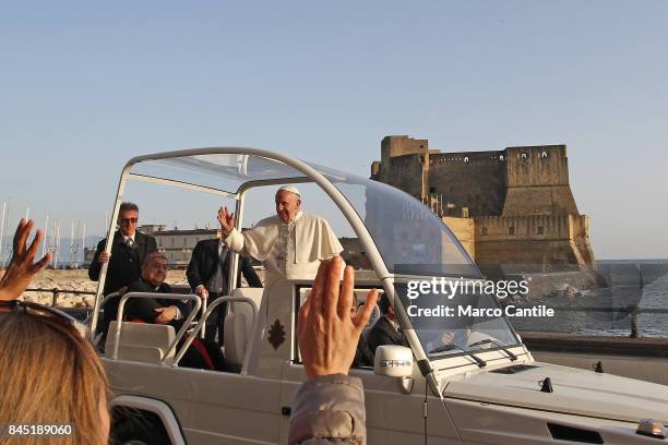 Pope Francis greets the faithful, on the seafront of Naples, during his visit to the city of Naples. Behind him the famous castle called Castel...