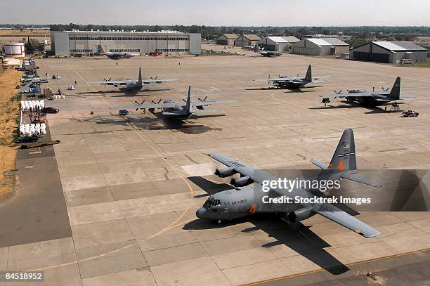 c-130 hercules aircraft stationed at an airbase. - military airfield stock pictures, royalty-free photos & images