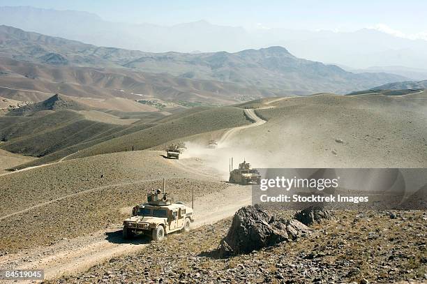 humvees traveling through roads in afghanistan. - military convoy imagens e fotografias de stock