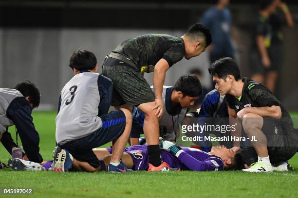 Shuichi Gonda of Sagan Tosu receives medical treatment before stretched off during the J.League J1 match between Vegalta Sendai and Sagan Tosu at...