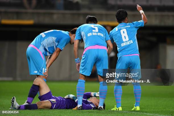 Masato Fujita of Sagan Tosu calls for medical treatment for Shuichi Gonda during the J.League J1 match between Vegalta Sendai and Sagan Tosu at...